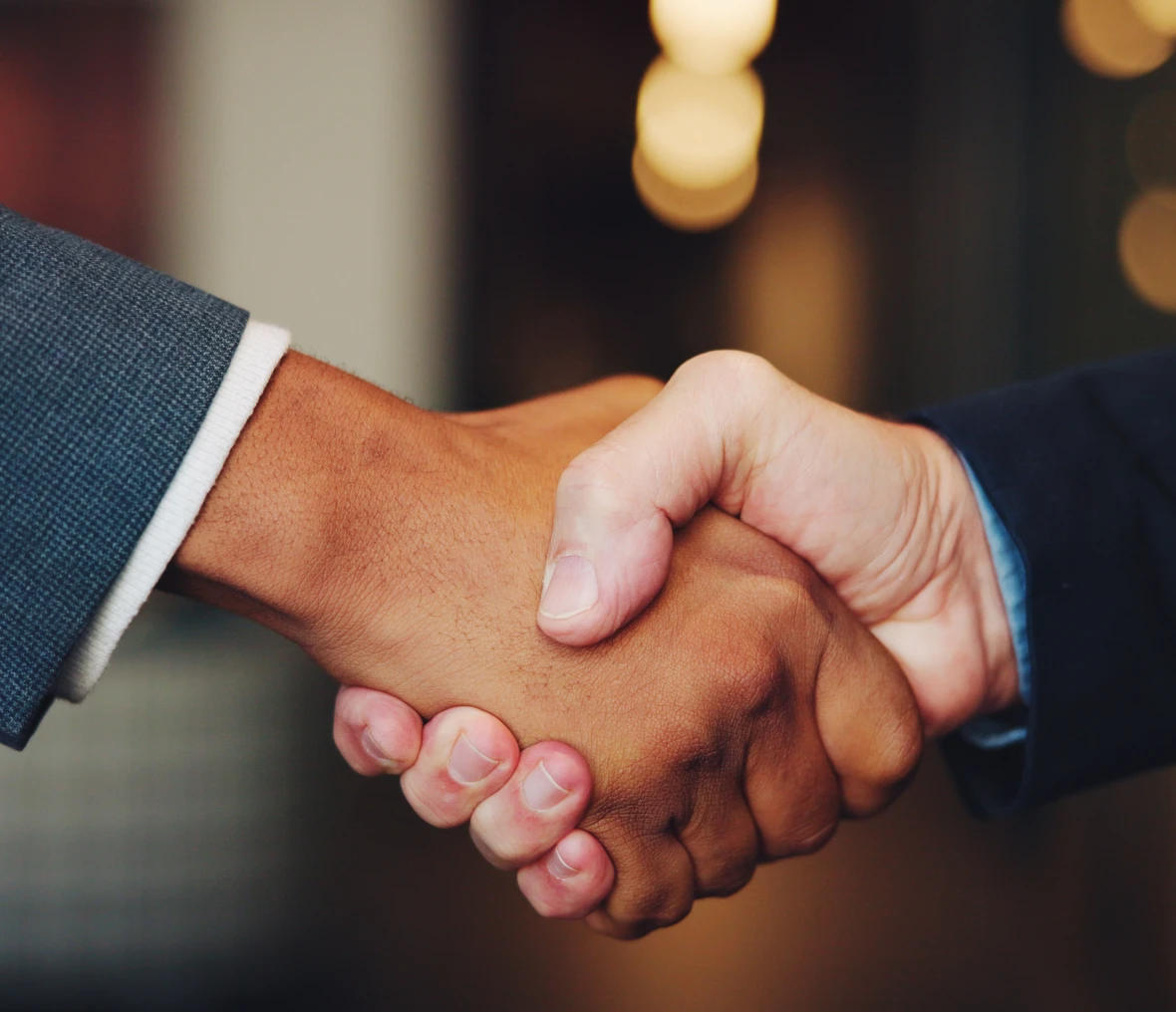 Close-up of hands shaking in agreement